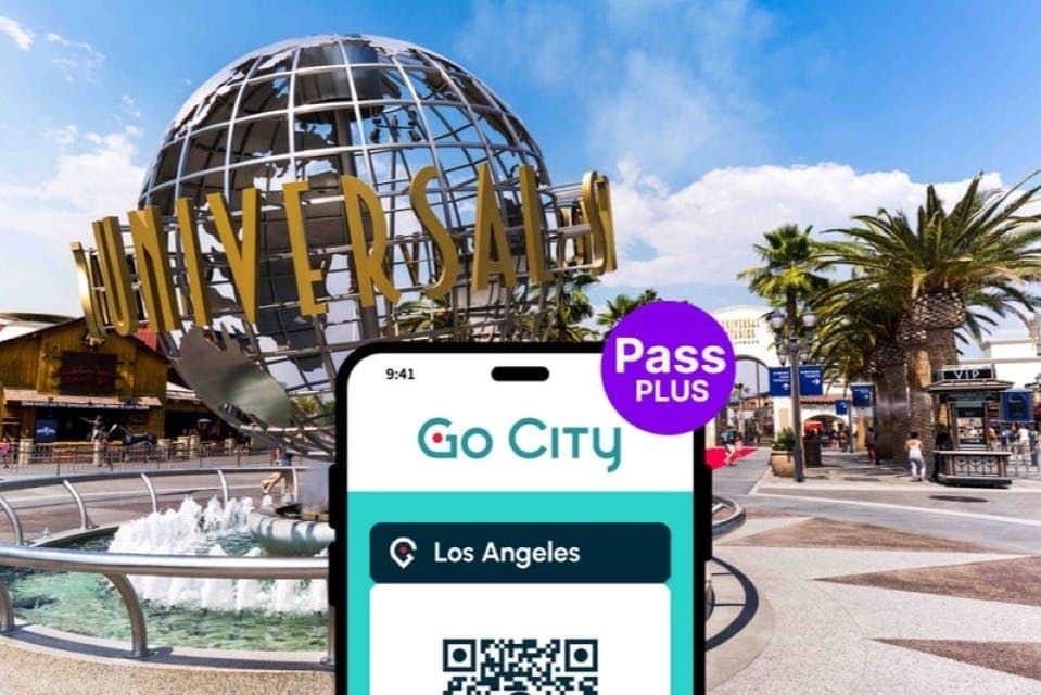 Smartphone displaying a "Go City" pass for Los Angeles with Universal Studios globe and surrounding area in the background.